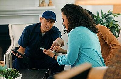 Foss Security technician explaining home camera system setup to homeowner