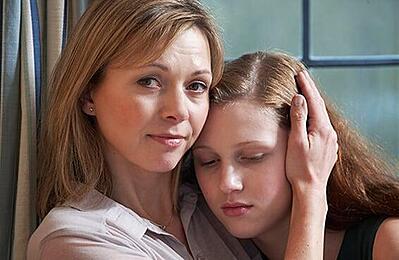 Mother comforting young daughter after a break-in