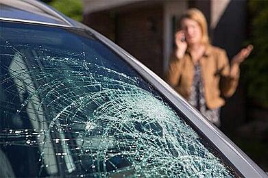 Home security camera footage of car vandalism in residential driveway at night